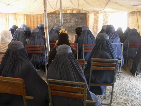 Afghan female university students, dressed in the traditional blue burqa, attend a math class under a tent at the Nangarhar University campus in Jalalabad in September  2012. Under Taliban rule, between 1994 and 2001 <a href="index.php?page=&url=http%3A%2F%2Fwww.cnn.com%2F2012%2F03%2F08%2Fopinion%2Fafghanistan-women-rights-barr%2F">women were banned from education and work</a>, even from leaving their homes unaccompanied.