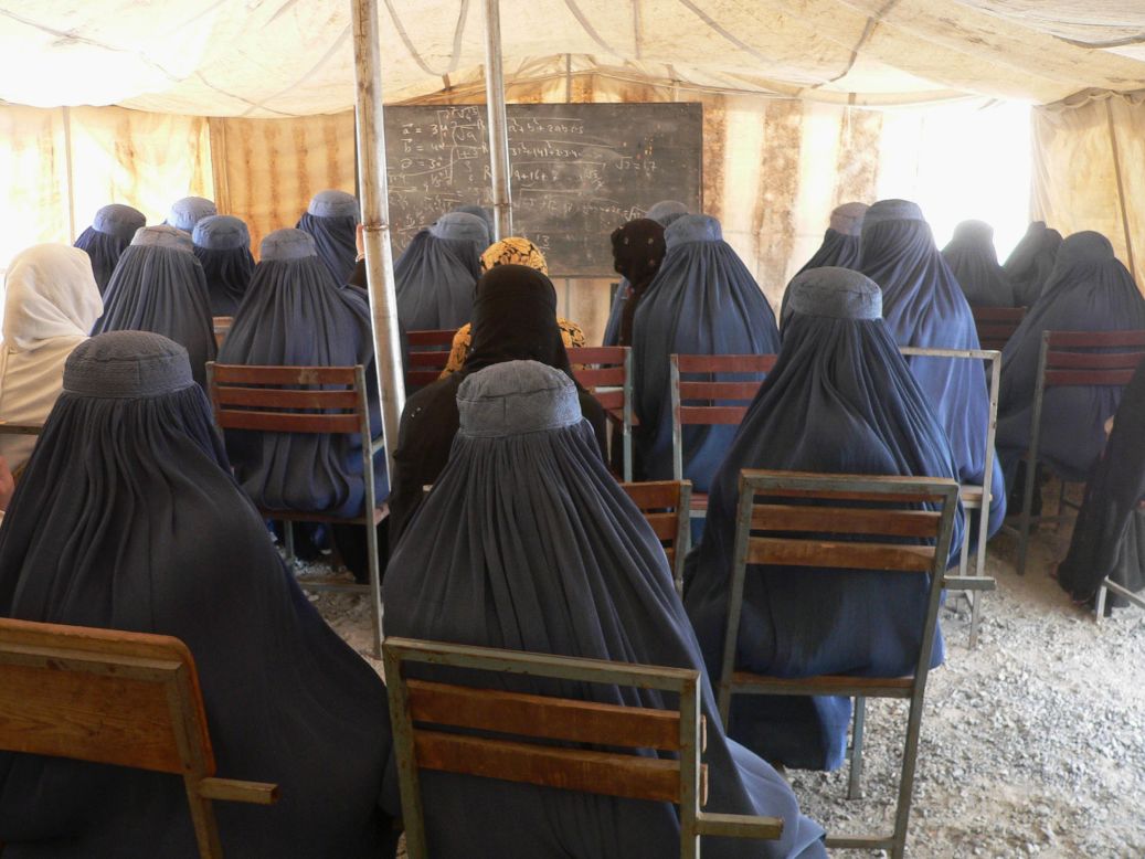 Afghan female university students, dressed in the traditional blue burqa, attend a math class under a tent at the Nangarhar University campus in Jalalabad in September  2012. Under Taliban rule, between 1994 and 2001 <a href="http://www.cnn.com/2012/03/08/opinion/afghanistan-women-rights-barr/">women were banned from education and work</a>, even from leaving their homes unaccompanied.