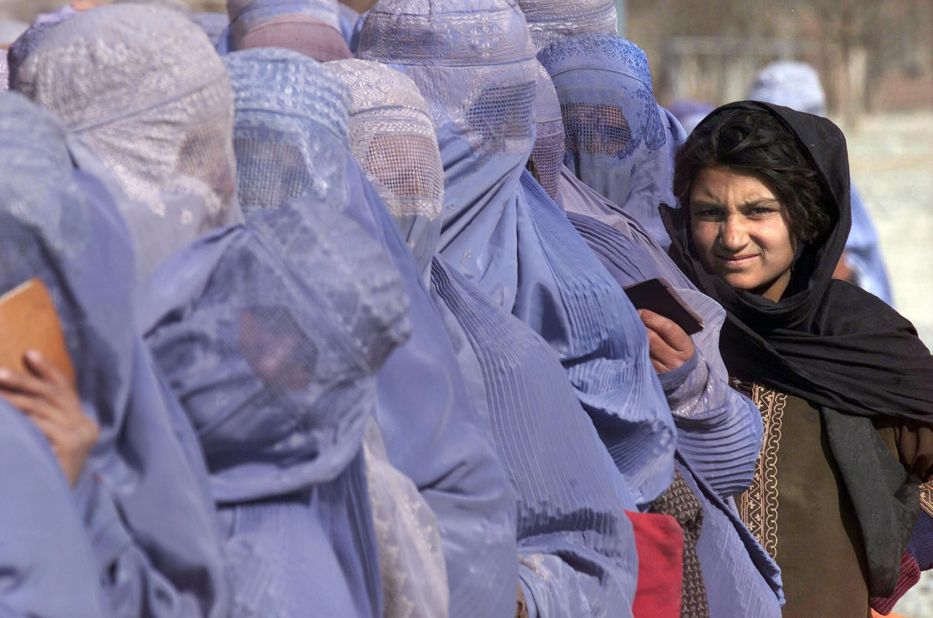 Women wait to receive food aid during a U.N. World Food Program scheme in Kabul in December 2001. "Even inside Afghanistan, female dress code varies hugely between regions," says Mosadiq. "You'll find the blue burqas across the whole country, but in urban centers like Kabul many women will only wear a hijab. In the north a white burqa is common, and in some Pashtun areas you'll find women in colorful dresses and just a headscarf."