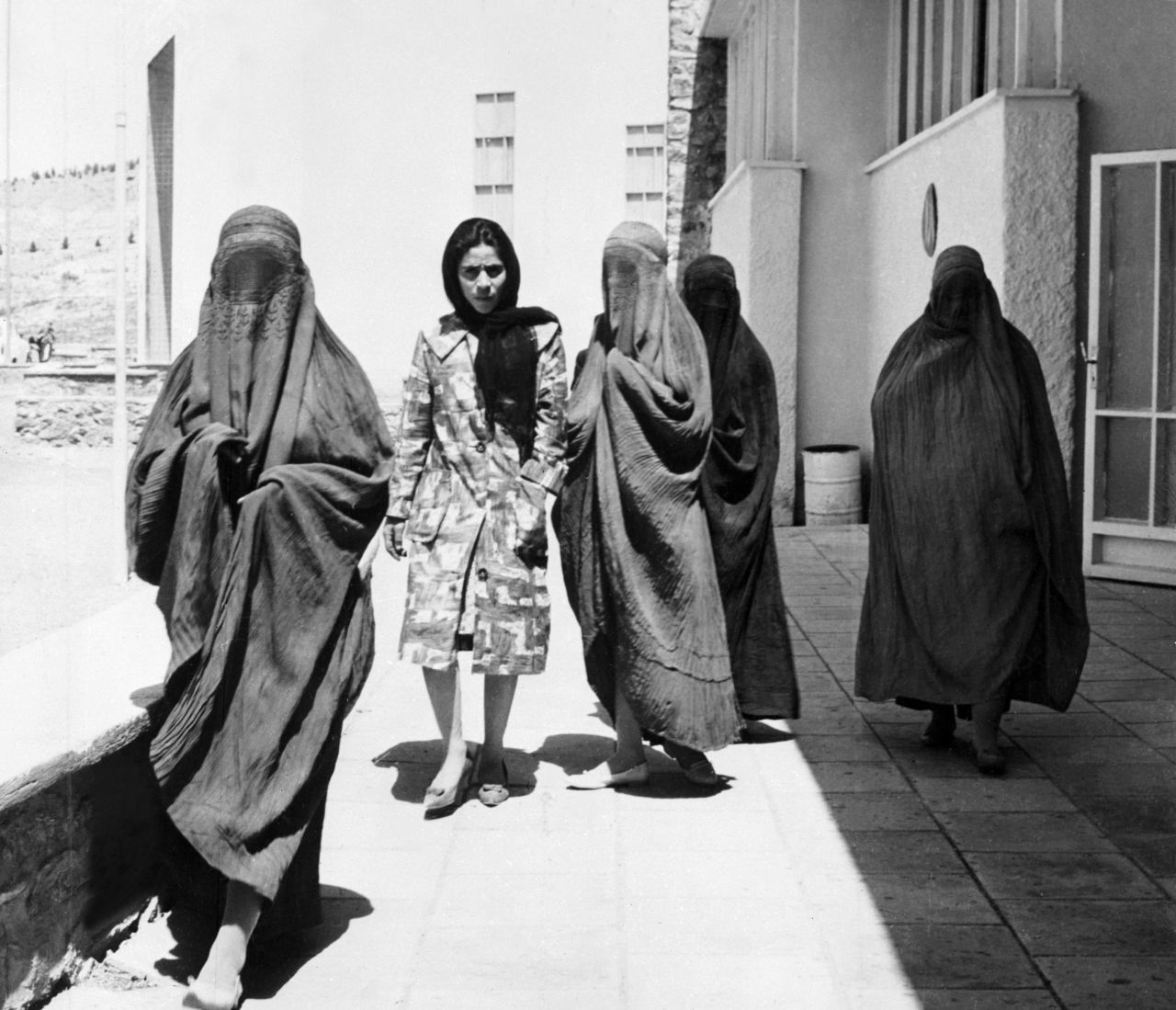 Taken in 1962, this picture shows Afghan women walking along a street in Kabul. Four of them are wearing burqas, whereas one walks comfortably among them in European-style dress. "When the mujahideen-led government replaced the Soviets in 1992, new restrictions on dress were formalized," says Mosadiq, "and obviously the Taliban's takeover in 1994 was the final nail in the coffin for any kind of independent dress for both men and women."