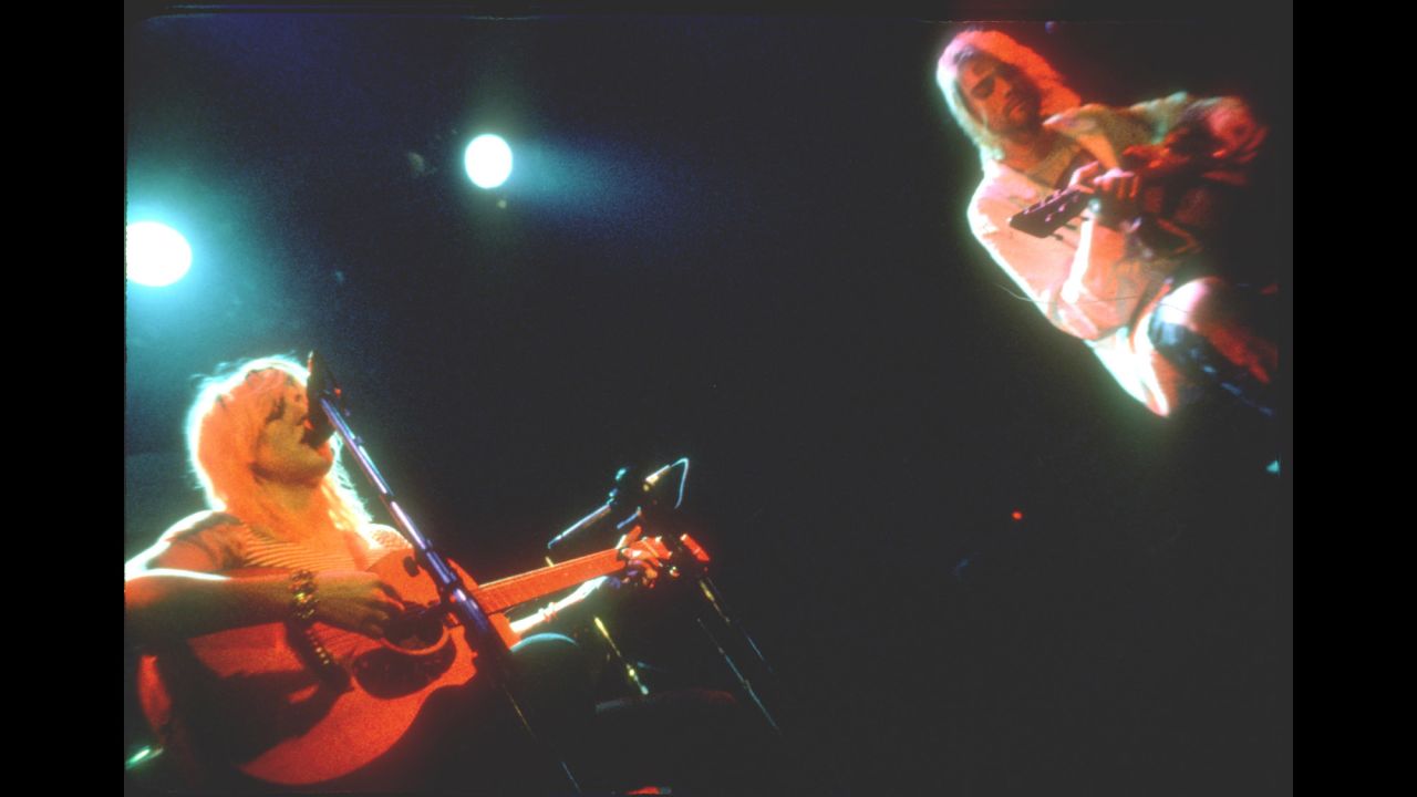 Cobain performs on stage with Love and her band Hole circa 1990.