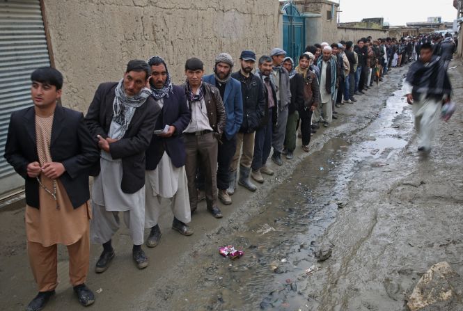 Men line up for registration before voting at a polling station in Kabul.