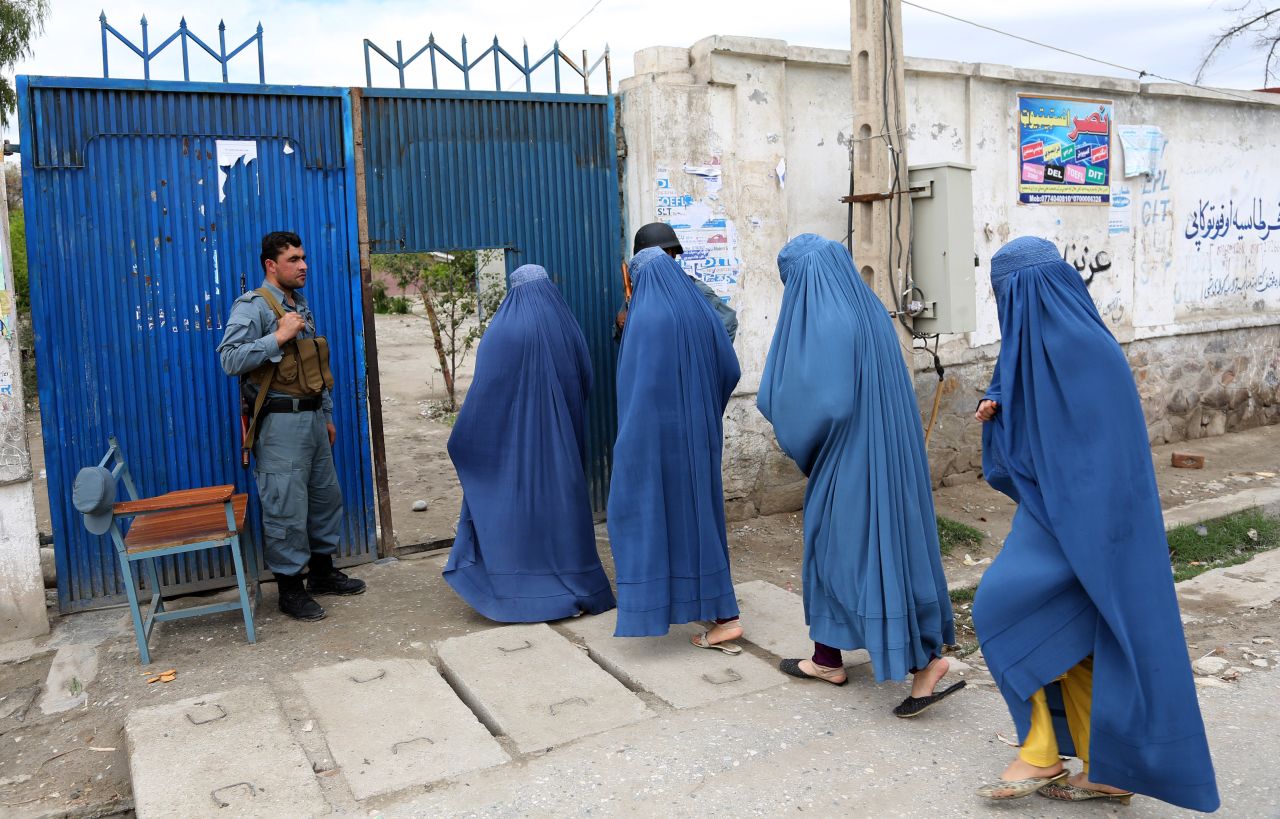 Women enter a polling station to vote in Jalalabad.