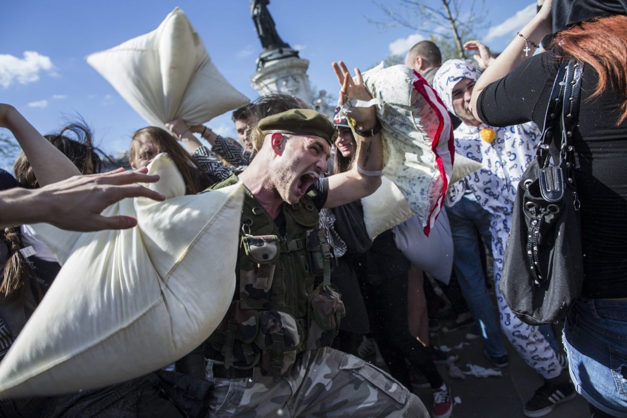 A camouflage-clad man prepares to land a blow as the fight takes place in Paris.