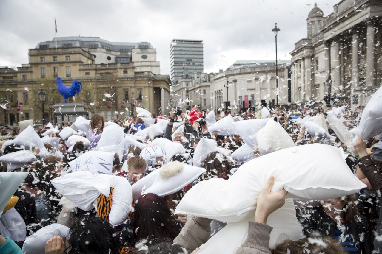 Combatants raise their fluffy armaments in London's Trafalgar Square.