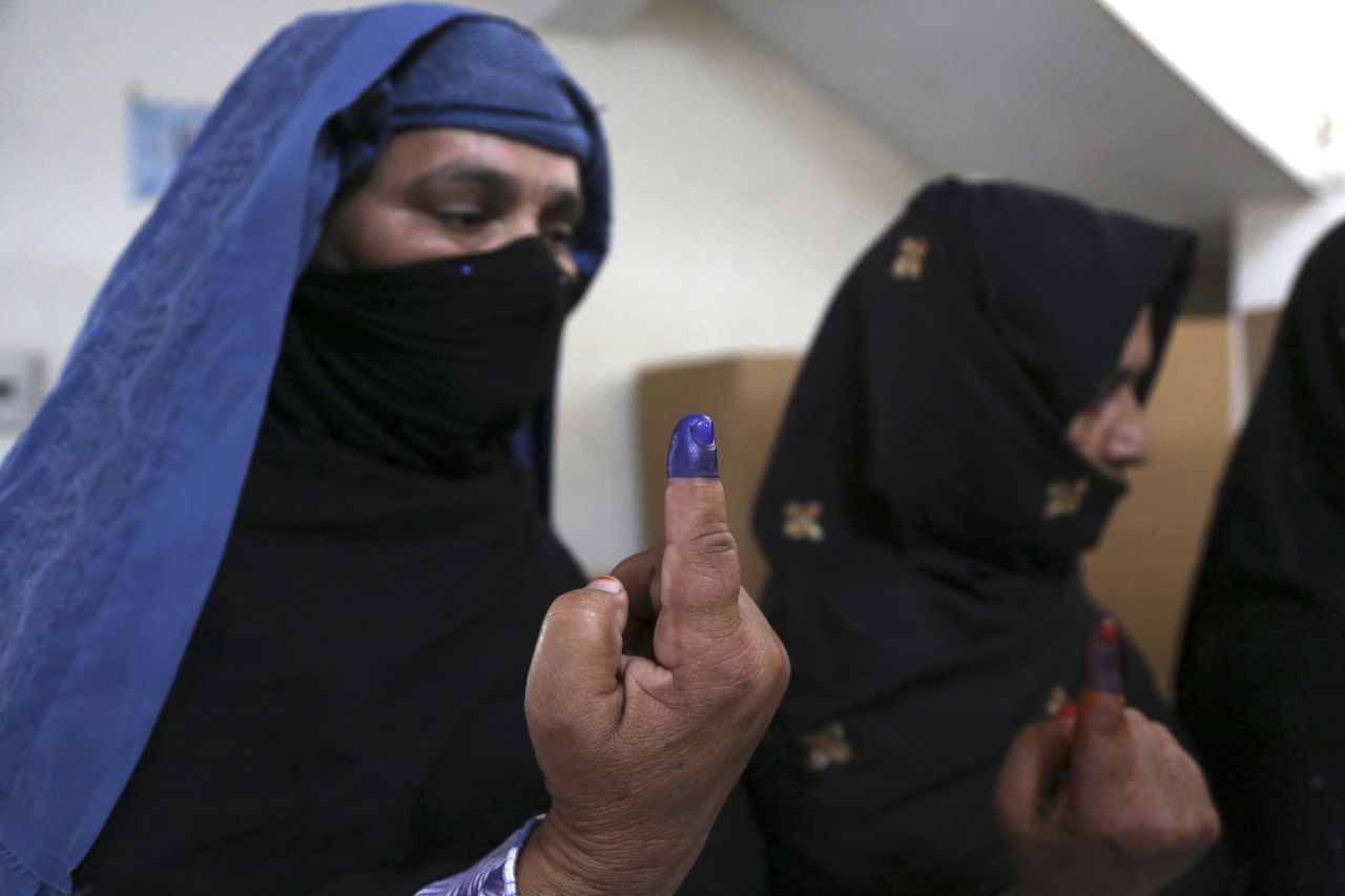 Afghan women show inked fingers after casting their votes at a polling station in Jalalabad, Afghanistan, on April 5. Despite threats from the Taliban to disrupt the vote and punish all involved, Afghans remain enthusiastic about the election. The top presidential contenders are Ashraf Ghani, Abdullah Abdullah and Zalmai Rassoul. The winner will replace President Hamid Karzai.