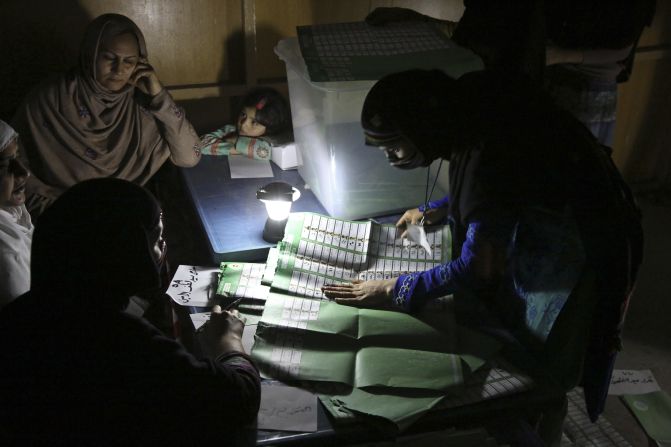 Afghan election workers count ballots by the light of a lantern at a polling station in Jalalabad, Afghanistan, on Saturday, April 5.