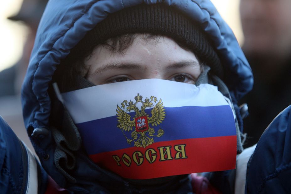A young demonstrator with his mouth covered by a Russian flag attends a pro-Russia rally outside the regional government administration building in Donetsk on Saturday, April 5.  