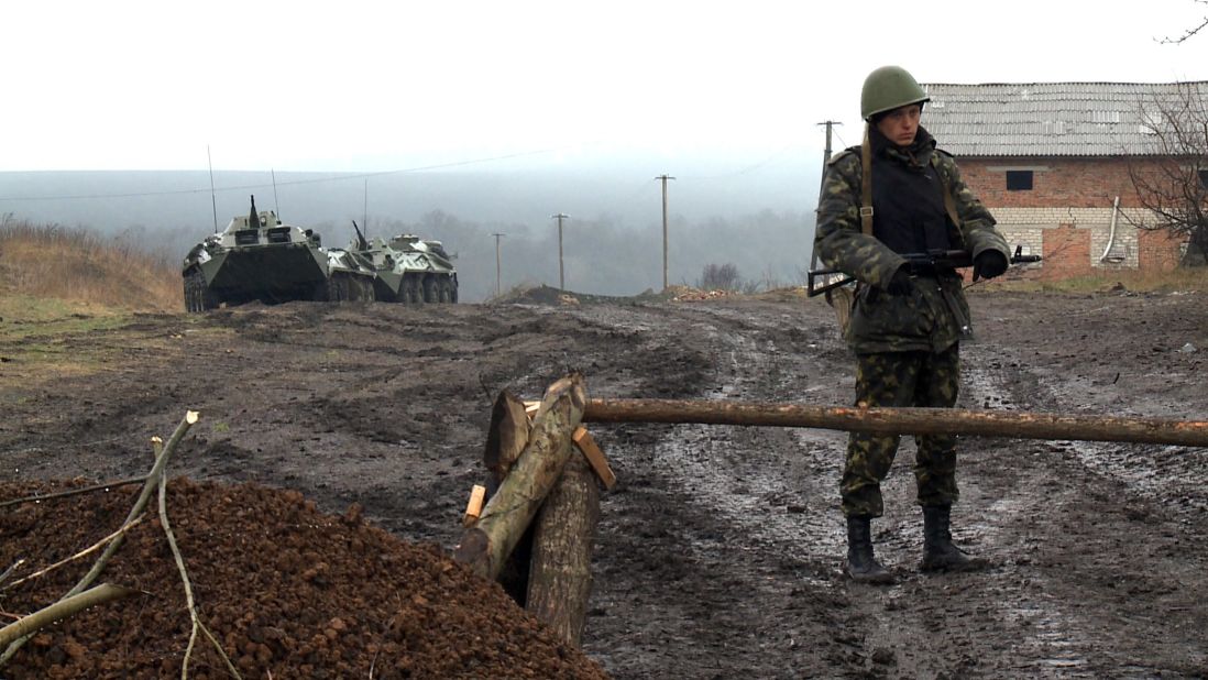 A Ukrainian soldier guards a road not far from Prokhody, a village near the Russian border, on April 5. Ukrainian and Western officials have voiced alarm about Russia's reported military buildup on Ukraine's eastern border. 