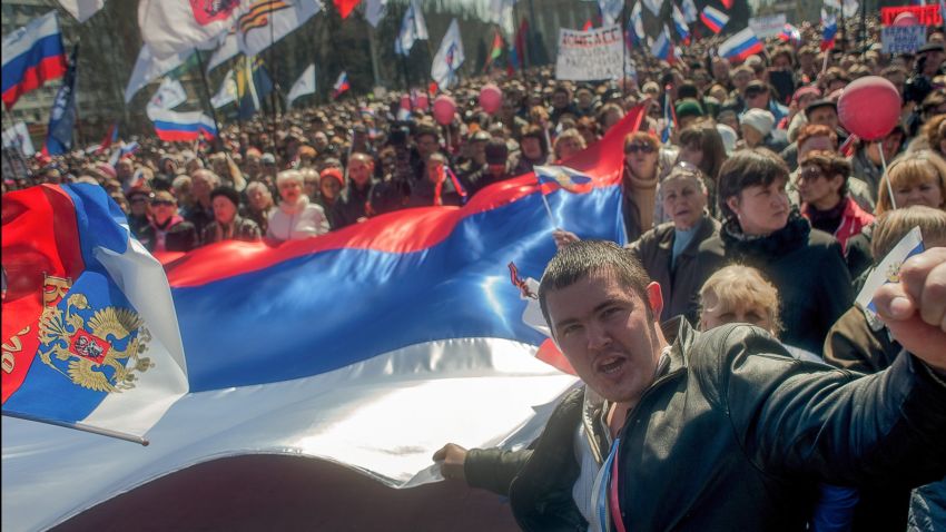 Pro-Russian protesters hold a giant Russian flag during their rally in downtown Donetsk, Ukraine, 06 April 2014. Protesters called for former President Yanukovych's return to Ukraine and to hold a referendum on the status of the Donetsk and Lugansk regions, similar to the recently held referendum in Crimea.