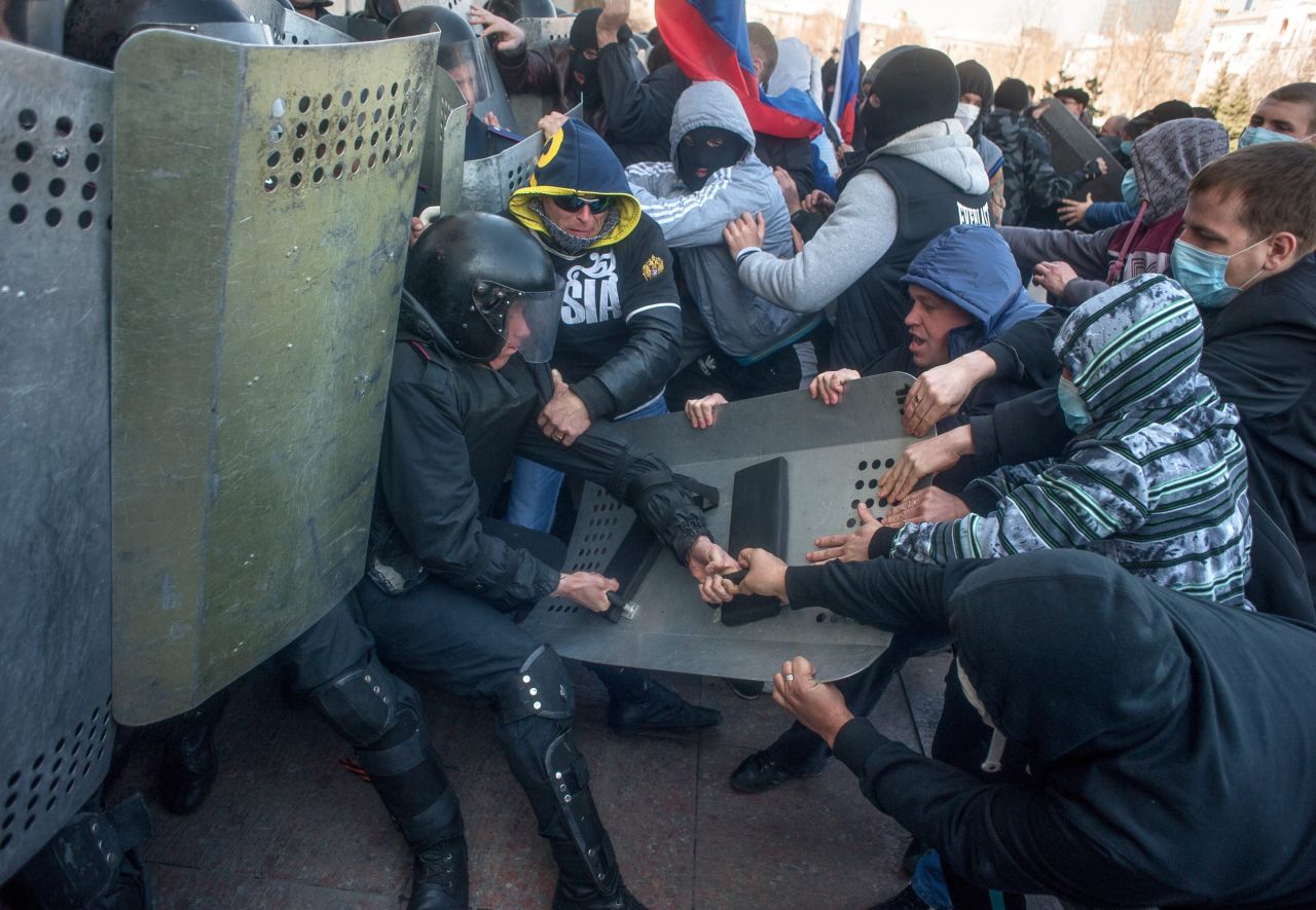 Pro-Russian protesters clash with police as they try to occupy a regional administration building in Donetsk on April 6. 