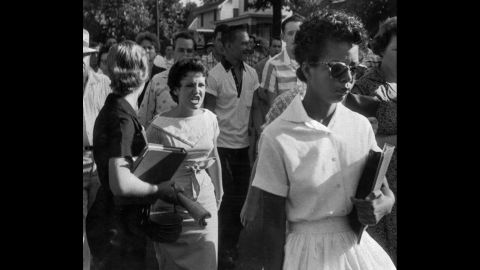 Students of Central High School in Little Rock, Arkansas, shout insults at Elizabeth Eckford as she walks toward the school building on the first day of school in 1957. Schools in Arkansas integrated races after the Supreme Court ruling in Brown v. Board of Education.