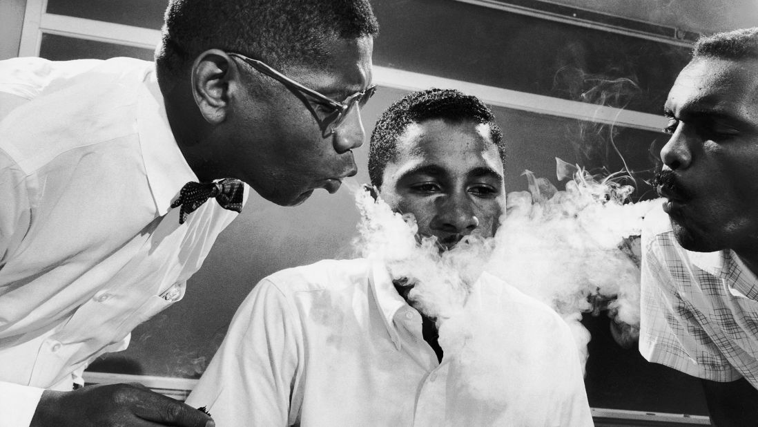 As part of his training for sit-in protests in 1960, student Virginius Thornton practices not reacting to smoke being blown in his face.
