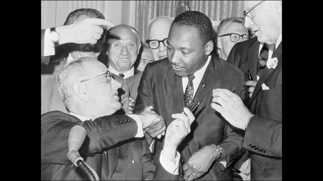 President Lyndon B. Johnson shakes hands with civil rights leader Martin Luther King Jr. after signing the Civil Rights Act of 1964. The LBJ Presidential Library is hosting a Civil Rights Summit this week to mark the 50th anniversary of the legislation.