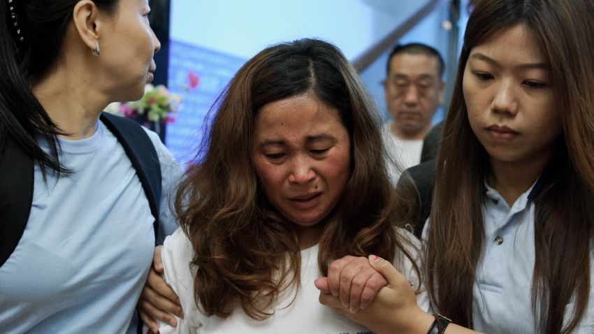 A Chinese relative (C) cries as she leaves after offering prayers for passengers onboard missing Malaysia Airlines (MAS) flight MH370 in Kuala Lumpur on April 6, 2014.