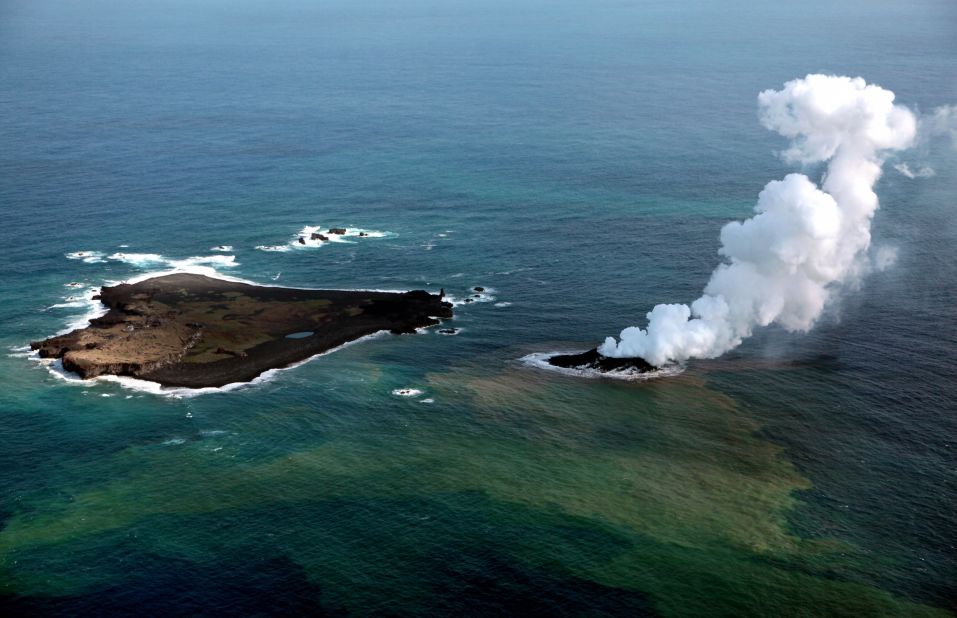 Niijima island spews jets of steam and ash near Nishinoshima island on November 2013. Niijima emerged about 500 meters (550 yards) from the older Nishinoshima.