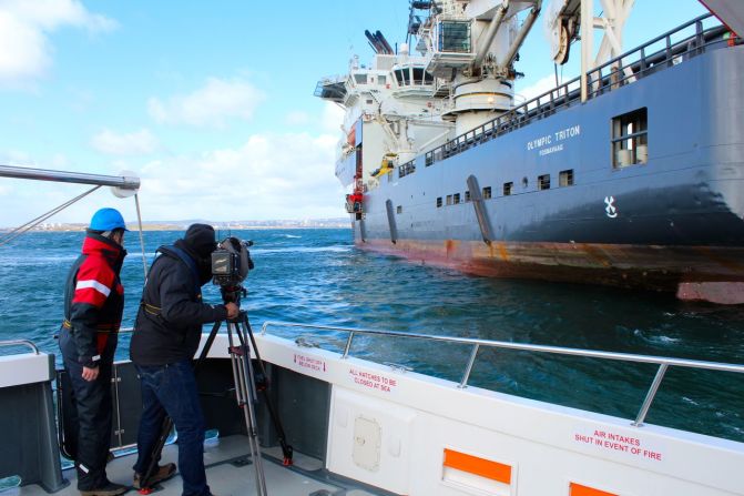 James: About 2 miles (3 kilometers) out to sea, between the waves, we got fleeting glimpses of the MV Olympic Triton, the support vessel for remotely operated underwater vehicles.  We could tell it was large, but as we drew closer to the 315-foot (96-meter) vessel it became clear it was not only large, but a serious piece of maritime engineering. 