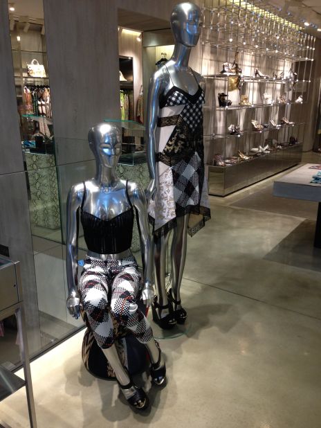 Female stylish mannequins in a shop window with Chanel bags