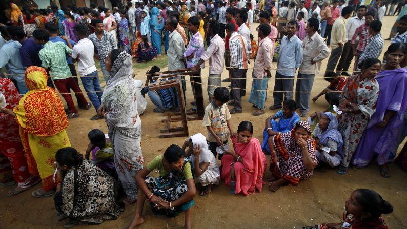 People wait in lines to cast their votes in Agartala on April 7.