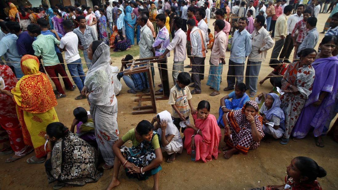 People wait in lines to cast their votes in Agartala on April 7.