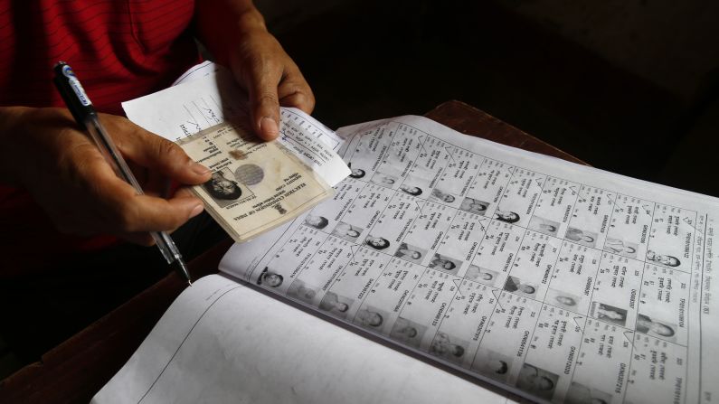 An election official checks the identity of a voter on April 7.