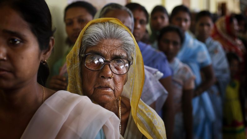 Indians in Dibrugarh stand in a line to cast their vote on April 7.