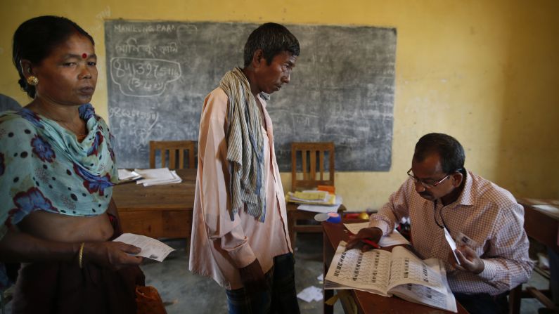 A polling officer in Agartala looks for a voter's name in the registered voter list April 7.