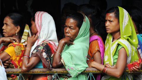 Women voters wait outside a polling station in Dibrugarh on April 7.