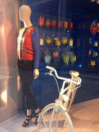 Fay's window display may be a more realistic portrayal of Milanese life than you think. Biking is no excuse to sacrifice style -- especially with a colorful down jacket.