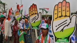 Supporters of India's ruling Congress party carrying the 'hand' party symbol dance during an election rally in Mumbai, India, Monday, April 7, 2014.