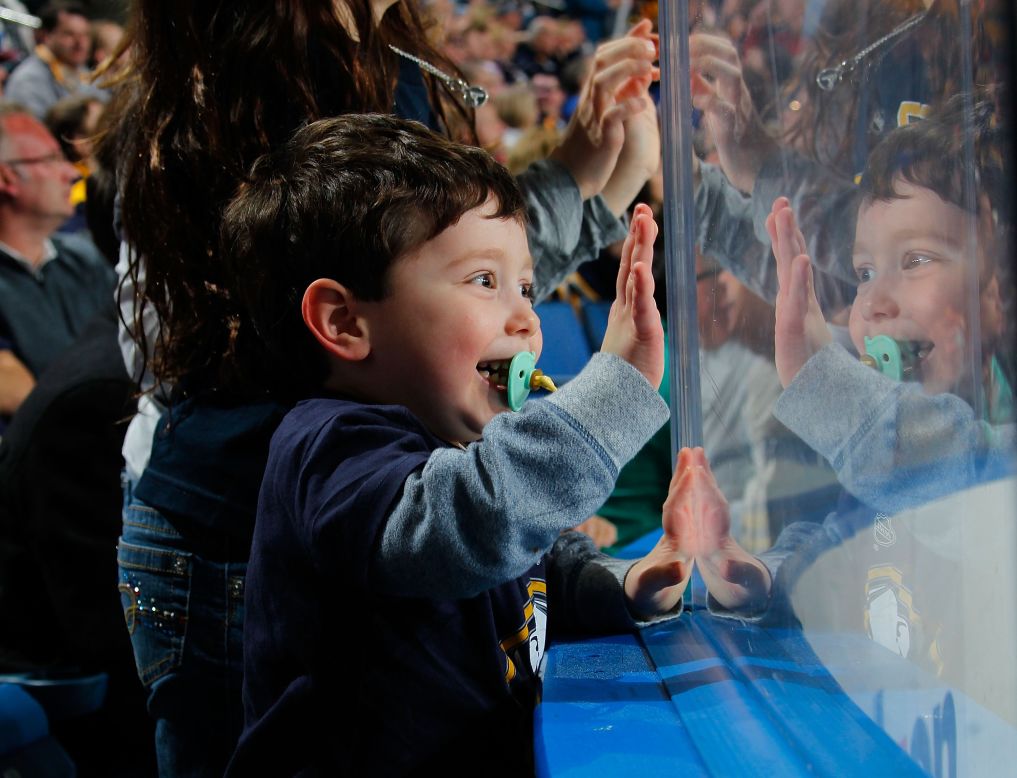 A young fan of the Buffalo Sabres celebrates a Sabres goal during an NHL hockey game Tuesday, April 1, in Buffalo, New York.