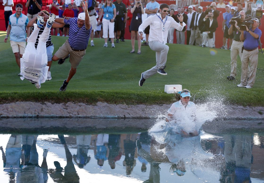 Golfer Lexi Thompson jumps into a pond Sunday, April 6, after winning the Kraft Nabisco Championship in Rancho Mirage, California.