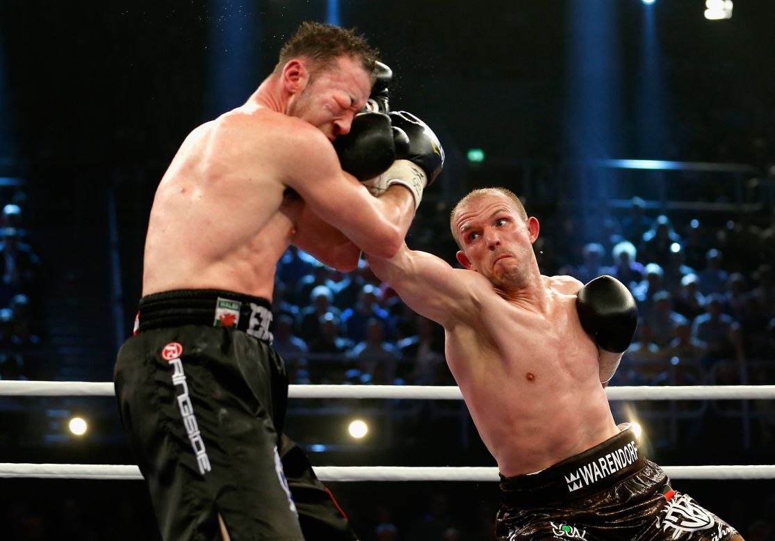 Jurgen Brahmer, right, punches Enzo Maccarinelli during their WBA light-heavyweight title fight Saturday, April 5, in Rostock, Germany.