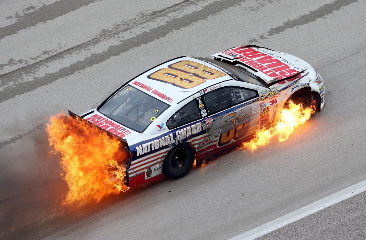 Flames come from the car of Dale Earnhardt Jr. after he crashed early in the NASCAR Sprint Cup race that was held Monday, April 7, at Texas Motor Speedway in Fort Worth, Texas. Earnhardt was OK and able to climb out of his car. 