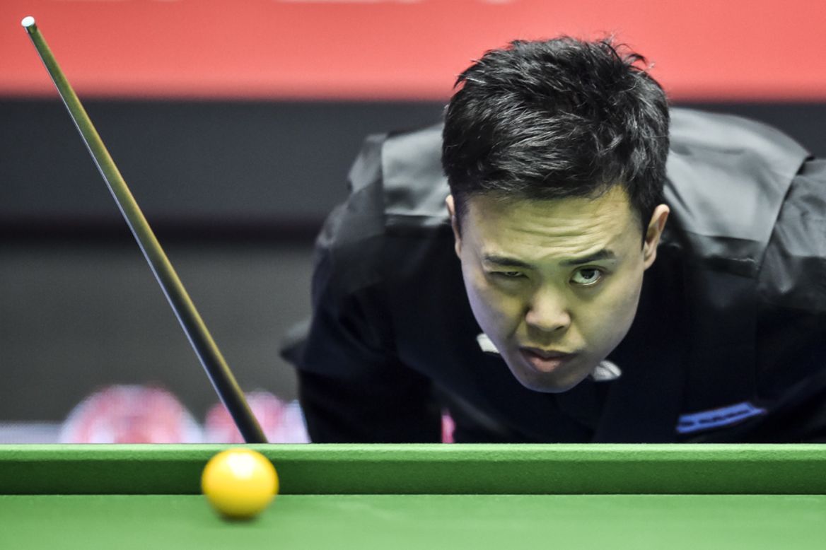 Marco Fu measures a shot during a snooker match at the China Open on Tuesday, April 1, in Beijing.