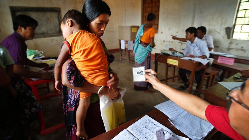 An election official checks the identity card of a voter during the first phase of elections in Agartala, in the northeastern state of Tripura, India, Monday, April 7, 2014. India started the world's largest election Monday, with voters in the remote northeast making their way past lush rice paddies and over rickety bamboo bridges to reach the polls. The country's 814 million electorate will vote in stages over the next five weeks. (AP Photo/Saurabh Das)