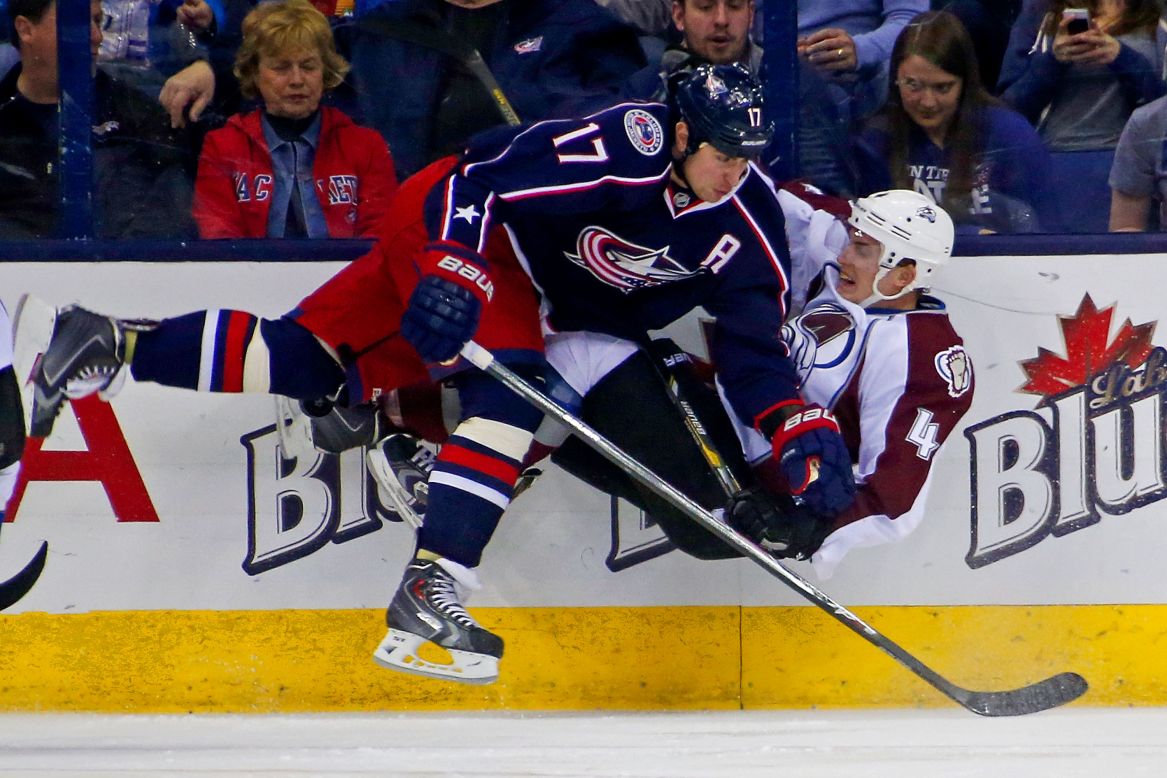 Columbus' Brandon Dubinsky, left, checks Colorado's Tyson Barrie while chasing the puck during an NHL game Tuesday, April 1, in Columbus, Ohio.