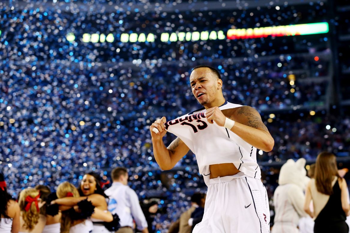Shabazz Napier of the Connecticut Huskies celebrates on the court after his team defeated Kentucky in the final of the NCAA Tournament on Monday, April 7.