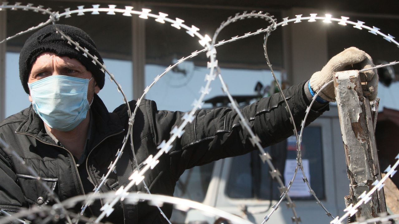 A pro-Russian man guards a barricade in front of the regional administration building in Donetsk, Ukraine, on Tuesday, April 8.