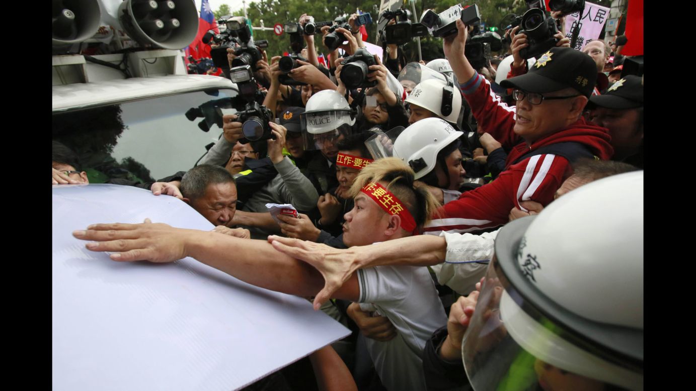 Supporters of the trade pact clash with police in Taipei on Tuesday, April 1. The trade agreement was signed last year with the intention of easing investment and trade between mainland China and Taiwan.