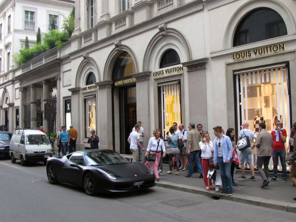 The only thing faster than a Supercar on Milan's Via Montenapoleone? The swiping of credit cards. Fashion's biggest names mix with Ferraris and Lamborghinis to ensure well-heeled shoppers arrive and depart in style. But where to cram those bulky bags?