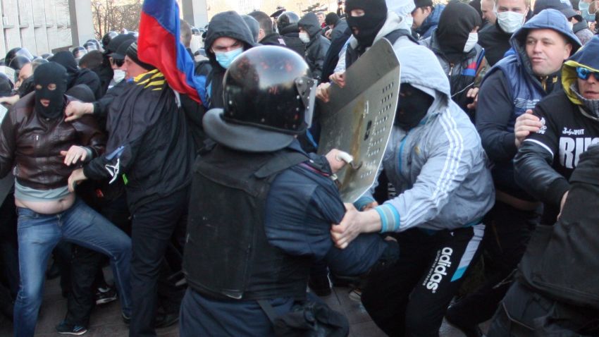 Pro-Russian supporters clash with members of the riot police as they storm the regional administration building in the eastern Ukrainian city of Donetsk on April 6, 2014.