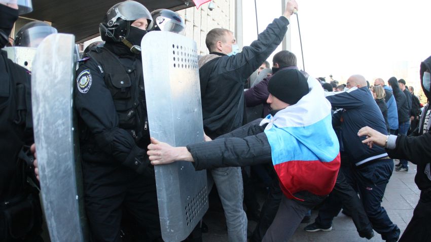 Pro-Russian supporters clash with members of the riot police as they storm the regional administration building in the eastern Ukrainian city of Donetsk on April 6, 2014.