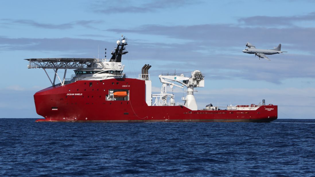 A Royal Australian Air Force AP-3C Orion, on a mission to drop sonar buoys to assist in the search, flies past the Australian vessel Ocean Shield on April 9, 2014.