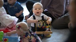 Prince George plays during a visit to Plunket nurse and parents group at Government House on April 9.