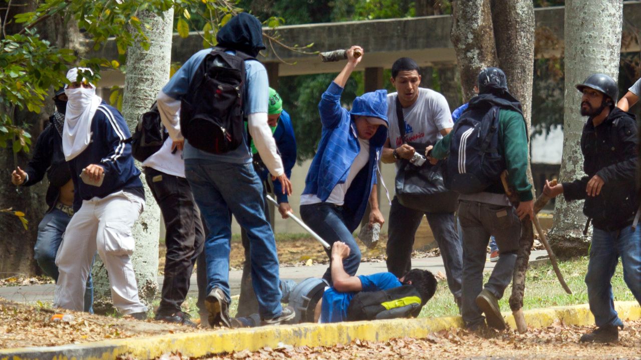 An opposition student struggles with members of a pro-government group at the Central University of Venezuela on April 3.