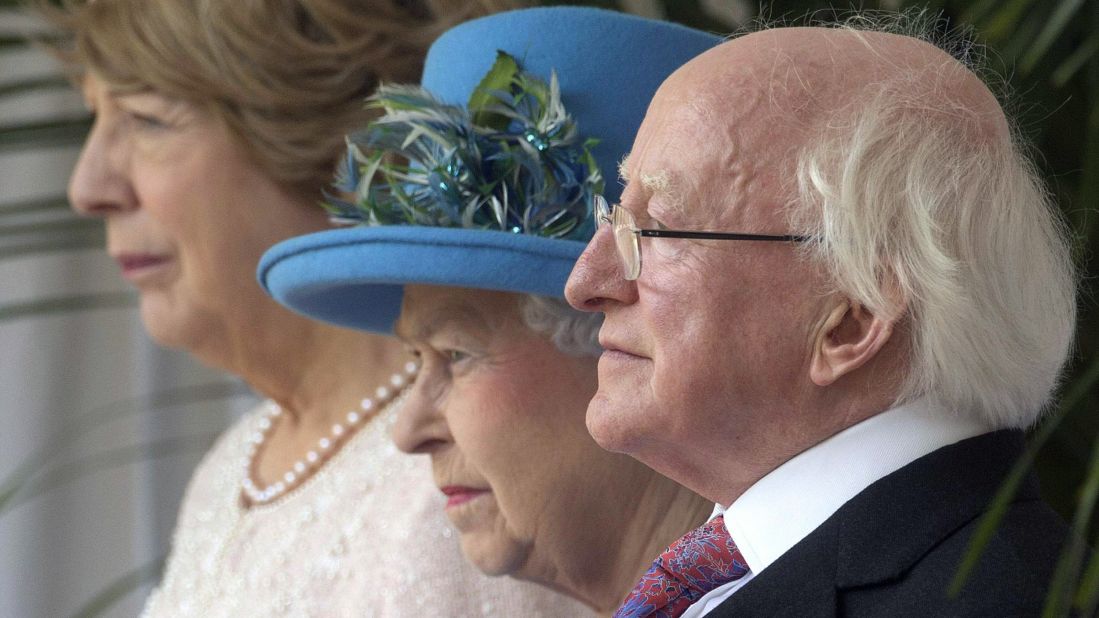 Queen Elizabeth, center, stands with Higgins and his wife during an official welcoming ceremony April 8 in Windsor, England.