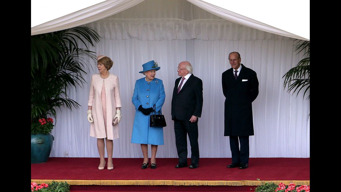 From left, Sabina Higgins, Queen Elizabeth, President Higgins and the queen's husband, Prince Philip, inspect the guard at Windsor Castle on April 8.