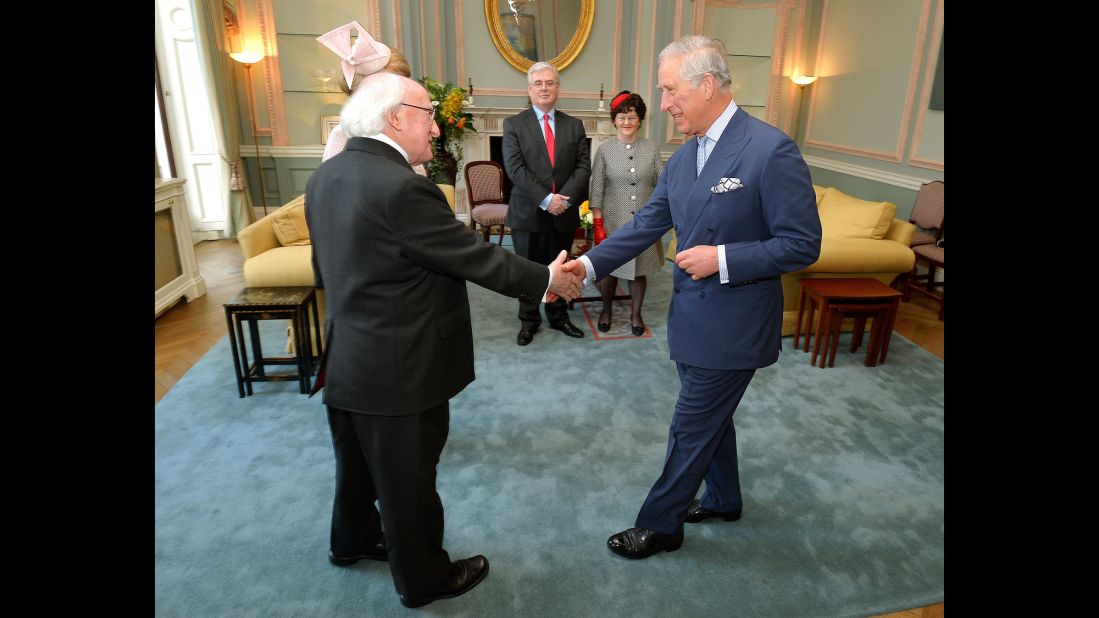At the start of his visit on April 8, Higgins shakes hands with Britain's Prince Charles at the Irish Embassy in London.