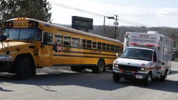 A Salvation Army disaster services vehicle drives past a school bus onto the campus of the Franklin Regional School District where several people were stabbed at Franklin Regional High School, Wednesday, April 9, 2014 in Murrysville, Pa., near Pittsburgh. The suspect, a male student, was taken into custody and being questioned. (AP Photo/Keith Srakocic)